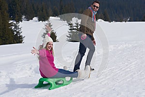Happy young couple having fun on fresh show on winter vacation