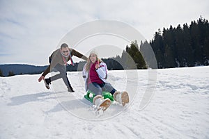 Happy young couple having fun on fresh show on winter vacation