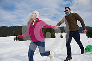 Happy young couple having fun on fresh show on winter vacation