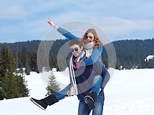 Happy young couple having fun on fresh show on winter vacation