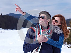 Happy young couple having fun on fresh show on winter vacation