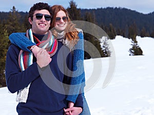 Happy young couple having fun on fresh show on winter vacation