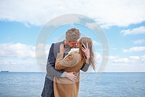 Happy young couple having fun and laughing together outdoors.