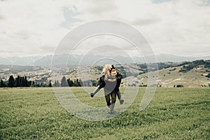 Happy young couple having fun in mountains. Travel happy emotions Lifestyle concept.