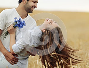 Happy young couple having fun outdoor in summer field