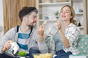 happy young couple having fun playing video games