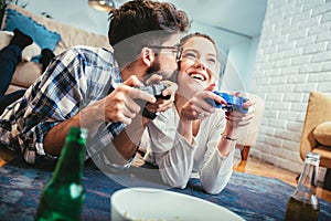 Happy young couple having fun playing videogames