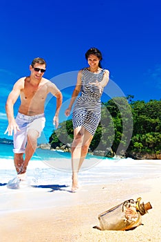 Happy young couple having fun on the shore of a tropical island.