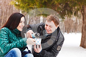 Happy young couple having fun in the winter park