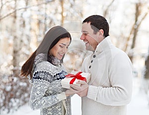 Happy young couple having fun in the winter park