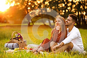 Happy young couple having picnic