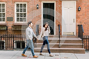 A happy young couple having a romantic moment in an urban setting in West Village in NYC