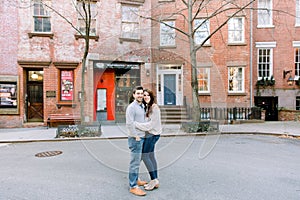 A happy young couple having a romantic moment in an urban setting in West Village in NYC