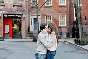 A happy young couple having a romantic moment in an urban setting in West Village in NYC