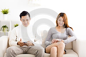 Happy young couple holding mobile phones