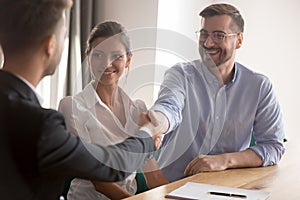 Happy young couple or hr team handshake lawyer job applicant