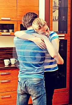 Happy young couple hugging in the kitchen