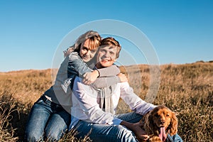 Happy young couple hugging and laughing outdoors.