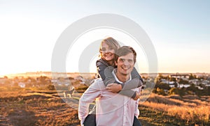 Happy young couple hugging and laughing outdoors.