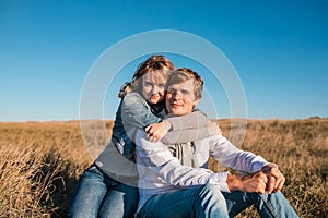 Happy young couple hugging and laughing outdoors.