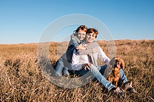 Happy young couple hugging and laughing outdoors.