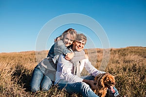 Happy young couple hugging and laughing outdoors.