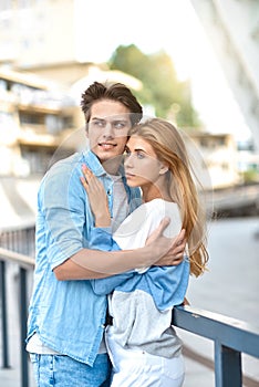 Happy young couple hugging and laughing outdoors