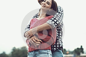 Happy young couple hugging and smiling