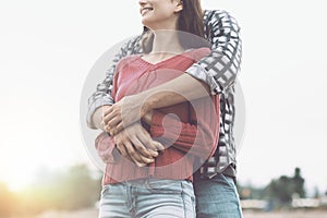 Happy young couple hugging and smiling