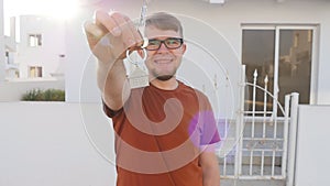 Happy young couple with keys to new home