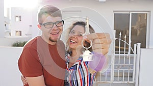 Happy young couple with keys to new home