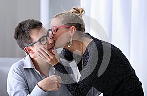 Happy young couple kissing in the office