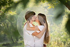 Happy young couple kissing outdoor