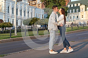 Happy young couple kissing on street. Tenderness, love, care