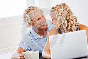 Happy young couple with laptop