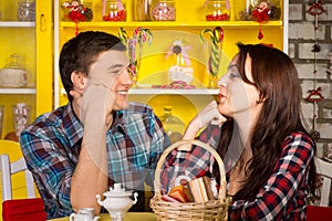 Happy Young Couple Looking Each Other at the Cafe