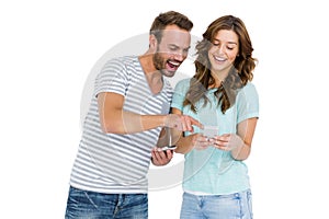 Happy young couple looking at mobile phone