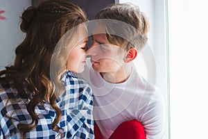 Happy young couple in love close to each other tenderly kissing