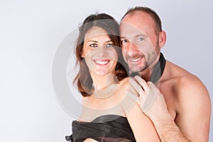 happy young couple in love or family posing on a gray background