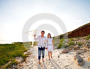 Happy young couple in love with flying a kite