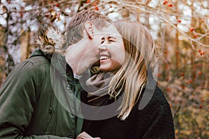 Happy young couple in love friends dressed in casual style walking together on autumn nature park forest, family advenure travel