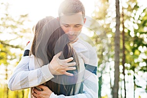 Happy young couple in love hugging. Park outdoors date. Loving couple