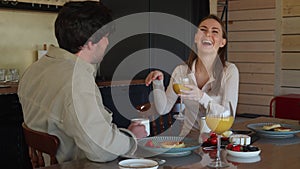 Happy young couple in love laughing, laughing, drinking tea or coffee, enjoying conversations, having fun together