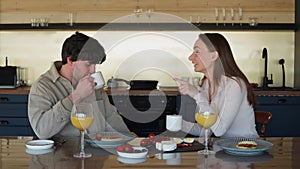 Happy young couple in love laughing, laughing, drinking tea or coffee, enjoying conversations, having fun together