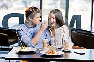 Happy young couple in love at romantic date in restaurant