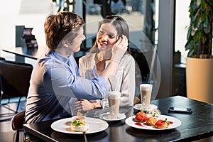 Happy young couple in love at romantic date in restaurant