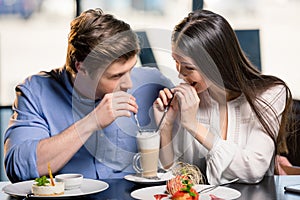 Happy young couple in love at romantic date in restaurant