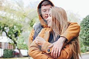 Happy young couple in love teenagers friends dressed in casual style on the autumn city street