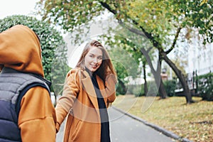 Happy young couple in love teenagers friends dressed in casual style on the autumn city street