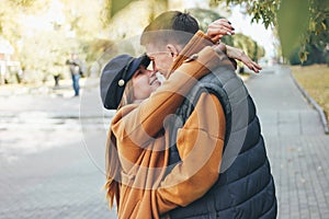 Happy young couple in love teenagers friends dressed in casual style walking together on city street in cold season